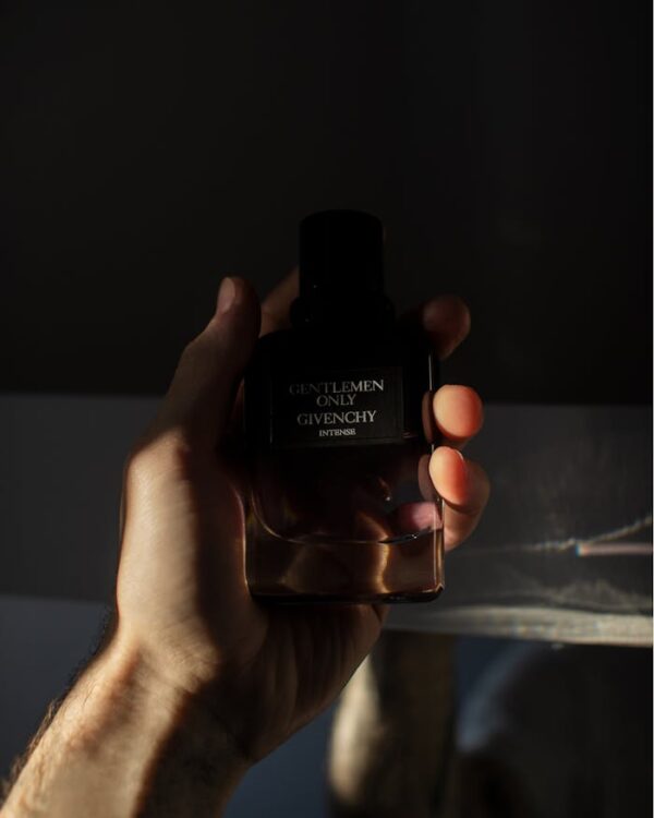 Photo of Person Holding a Gentlemen Only Cologne Bottle by Givenchy